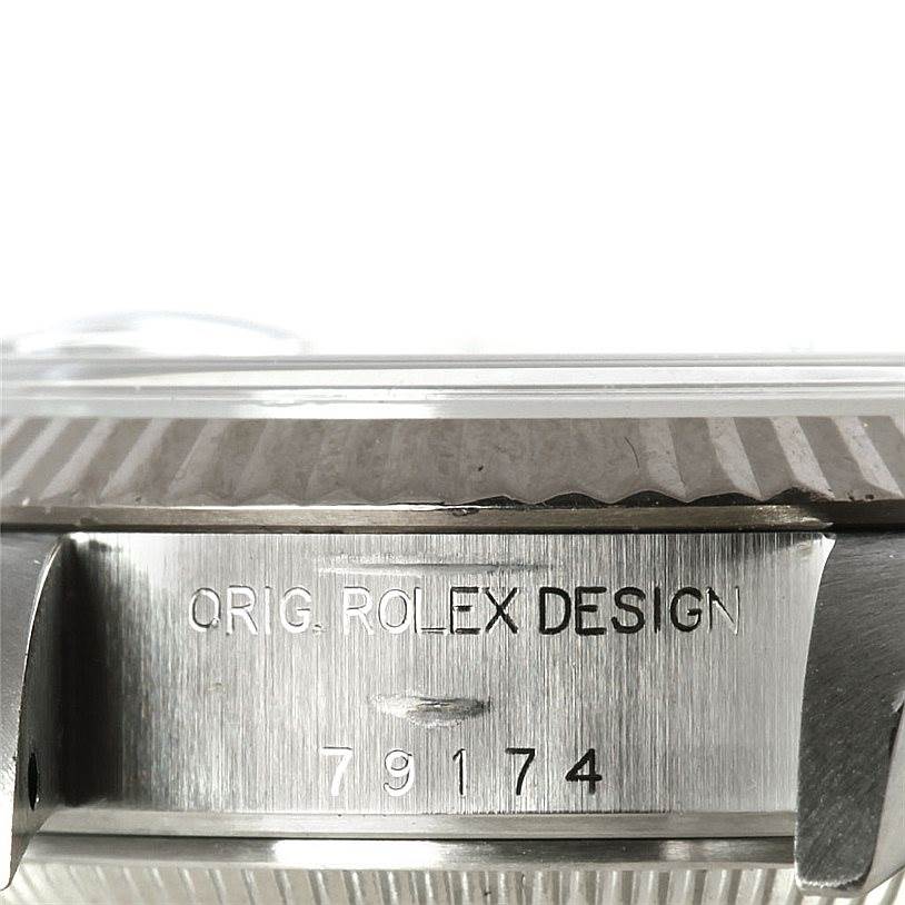 This image shows a close-up of the side of a Rolex Datejust 79174 Women's Stainless Steel Mother of Pearl Dial 79174 Women's Stainless Steel Mother of Pearl Dial watch, highlighting the "ORIG. ROLEX DESIGN" engraving and model number.