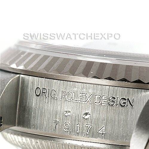 The image shows a close-up of the case and fluted bezel of a Rolex Datejust 79174 Women's Stainless Steel Silver Dial 79174 Women's Stainless Steel Silver Dial watch, highlighting the engraving.