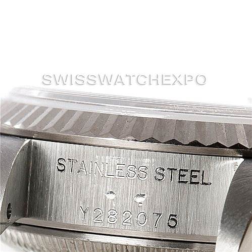 This close-up image shows the side of a Rolex Datejust 79174 Women's Stainless Steel Silver Dial 79174 Women's Stainless Steel Silver Dial watch, highlighting the stainless steel engraving and part of the fluted bezel.