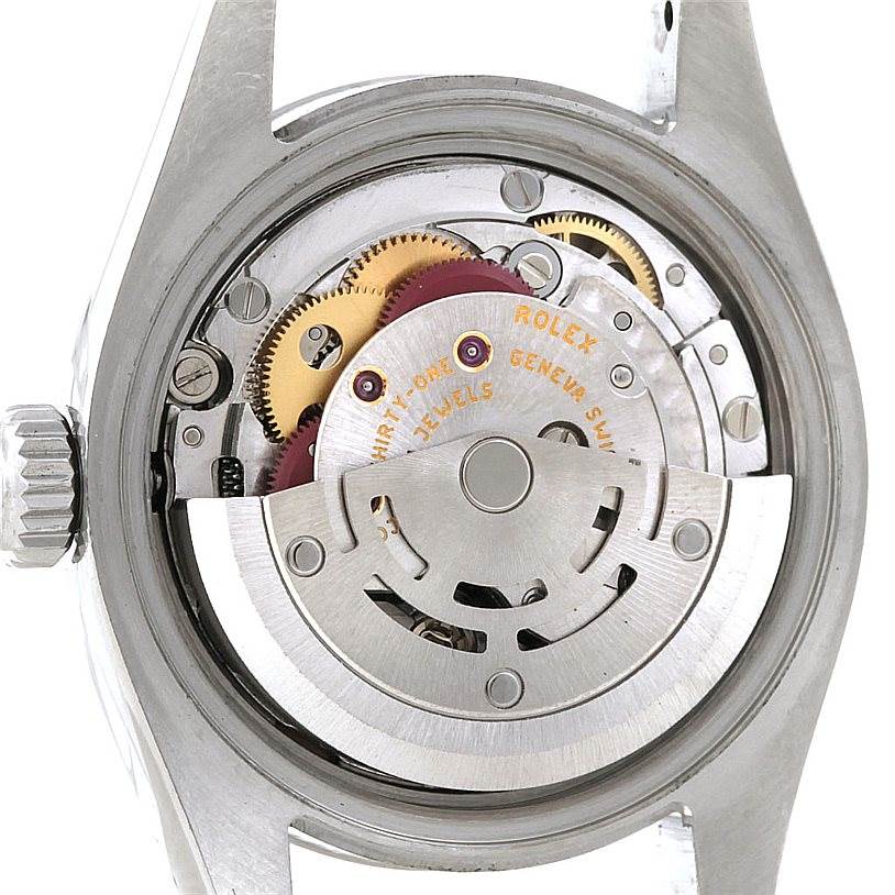 This image shows the movement mechanism of a Rolex Datejust 179160 Women's Stainless Steel Pink Dial 179160 Women's Stainless Steel Pink Dial watch from the backside, revealing gears and components.