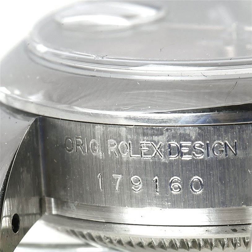 This image shows a close-up side view of the casing of a Rolex Datejust 179160 Women's Stainless Steel Pink Dial 179160 Women's Stainless Steel Pink Dial watch with engravings.