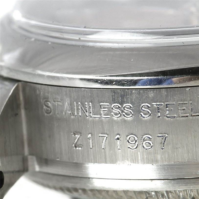 The image shows a close-up side view of a Rolex Datejust 179160 Women's Stainless Steel Pink Dial 179160 Women's Stainless Steel Pink Dial watch, highlighting the stainless steel case and serial number.