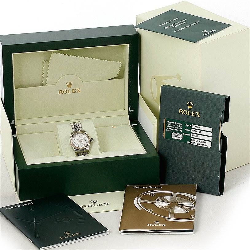 The image shows a Rolex Datejust 179174 Women's Stainless Steel Silver Dial 179174 Women's Stainless Steel Silver Dial watch in its open box, accompanied by manuals and a warranty card.