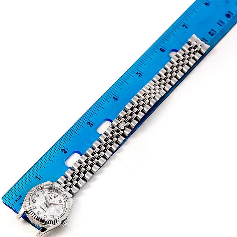 The image shows a Rolex Datejust 179174 Women's Stainless Steel Silver Dial 179174 Women's Stainless Steel Silver Dial watch laid flat with a blue ruler beside it, displaying the face and full bracelet.