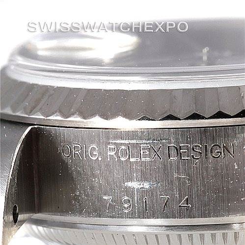 The image shows a close-up angle of the side part of the Rolex Datejust 79174 Women's Stainless Steel White Dial 79174 Women's Stainless Steel White Dial watch, highlighting its engraved serial numbers and the phrase "ORIG. ROLEX DESIGN".