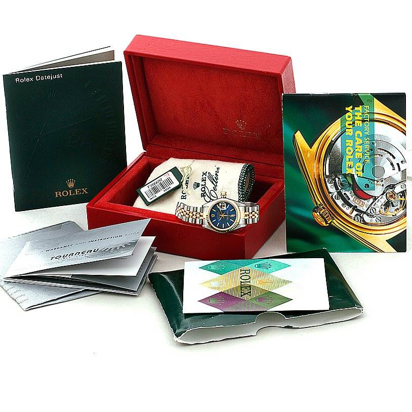 This image shows a Rolex Datejust 79173 Women's Stainless Steel Blue Dial 79173 Women's Stainless Steel Blue Dial watch displayed in an open red box, along with various booklets and warranty cards.