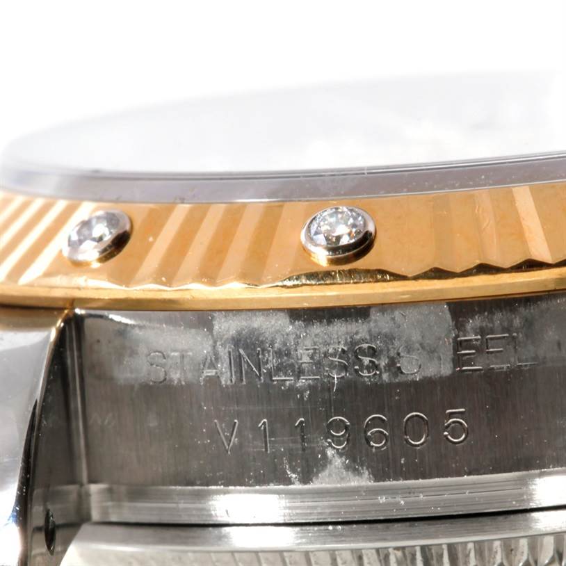 Close-up of the Rolex Datejust 179313 Women
s Stainless Steel Beige Dial 179313 Women
s Stainless Steel Beige Dial watch showing the side of the case, bezel with diamonds, and the serial number.