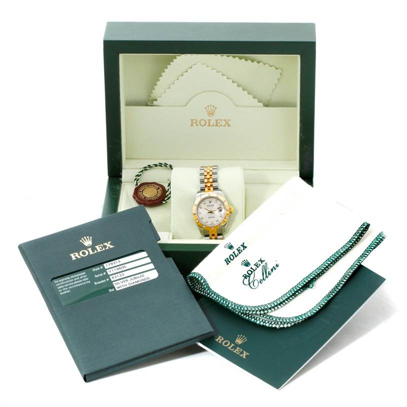 The Rolex Datejust 179313 Women
s Stainless Steel Beige Dial 179313 Women
s Stainless Steel Beige Dial watch is shown in its box with accessories, including the certificate, booklet, and tags.