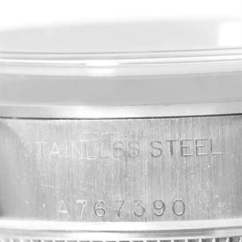 This image shows a close-up of the serial number and "Stainless Steel" engraving on the case of a Rolex Datejust 79160 Women's Stainless Steel White Dial 79160 Women's Stainless Steel White Dial watch.