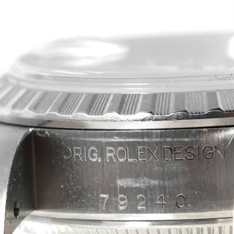 The image shows a close-up of the side of the Rolex Datejust 79160 Women's Stainless Steel Silver Dial 79160 Women's Stainless Steel Silver Dial watch case, highlighting the bezel and engraved text.