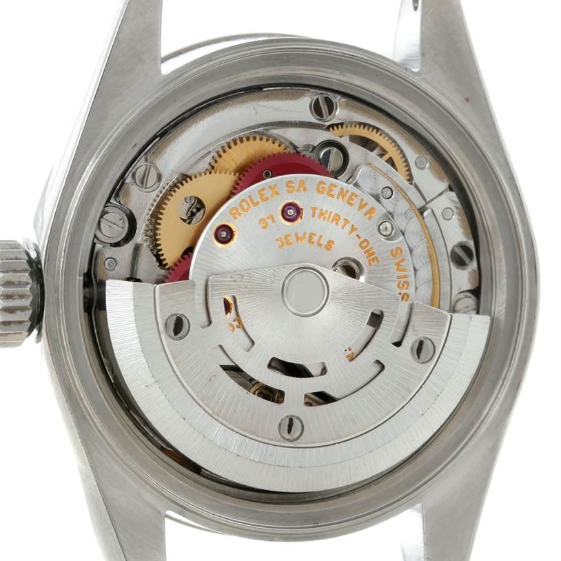 The image shows the back of the Rolex Datejust 79174 Women's Stainless Steel White Dial 79174 Women's Stainless Steel White Dial watch, highlighting its internal movement and gears.