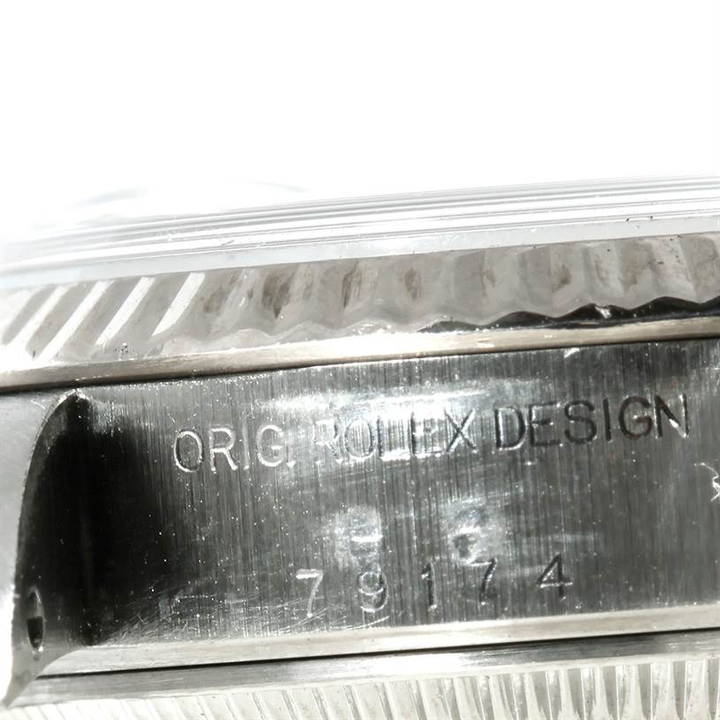 The image shows a close-up of the side of the Rolex Datejust 79174 Women's Stainless Steel White Dial 79174 Women's Stainless Steel White Dial watch case, highlighting the "Orig. Rolex Design" engraving.