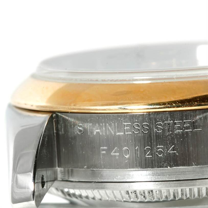 The image shows a close-up side view of a stainless steel case with the serial number of a Rolex Datejust 179163 Women's Steel and Gold (two tone) White Dial 179163 Women's Steel and Gold (two tone) White Dial watch.