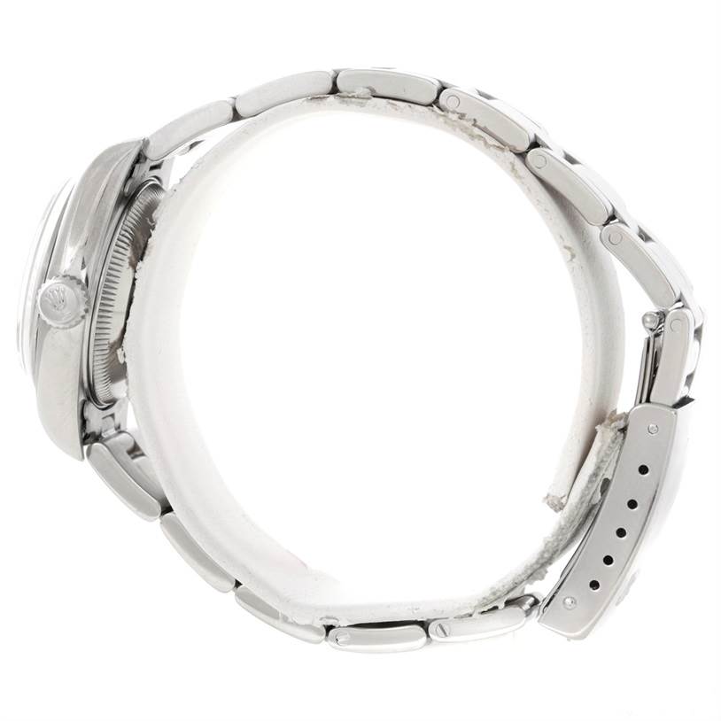 The Rolex Datejust 79160 Women's Stainless Steel White Dial 79160 Women's Stainless Steel White Dial watch is shown from the side, displaying the case, crown, and bracelet with its clasp.