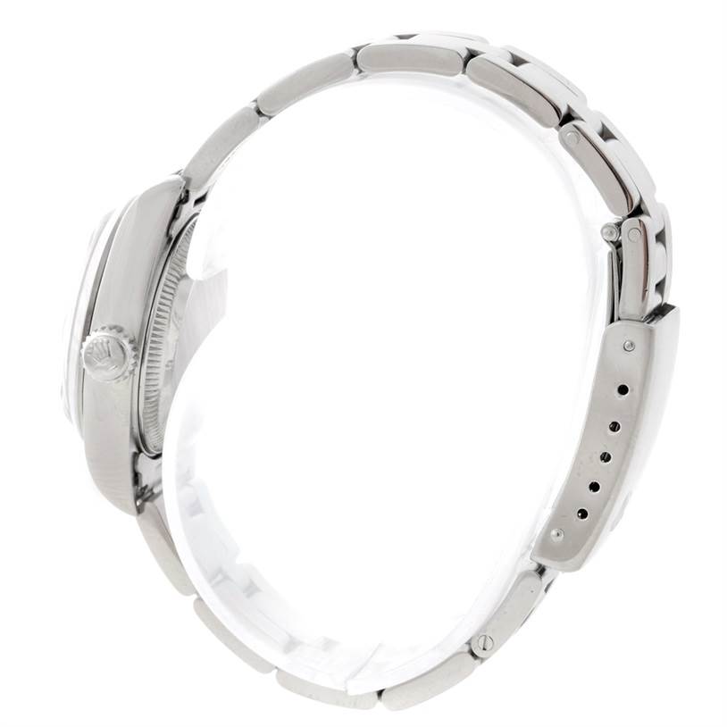 This image shows a side profile of the Rolex Datejust 69160 Women
s Stainless Steel Blue Dial 69160 Women
s Stainless Steel Blue Dial watch highlighting the crown, case, and bracelet.