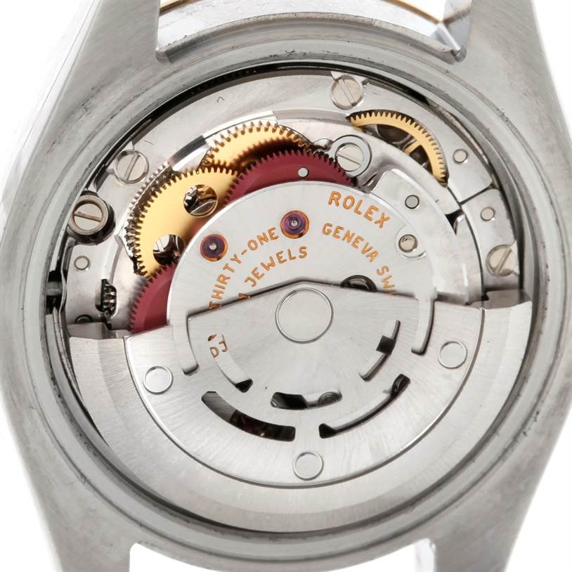 This image shows the internal mechanics of the Rolex Datejust 179163 Women's Steel and Gold (two tone) Silver Dial 179163 Women's Steel and Gold (two tone) Silver Dial watch from a back view, highlighting gears and movement components.