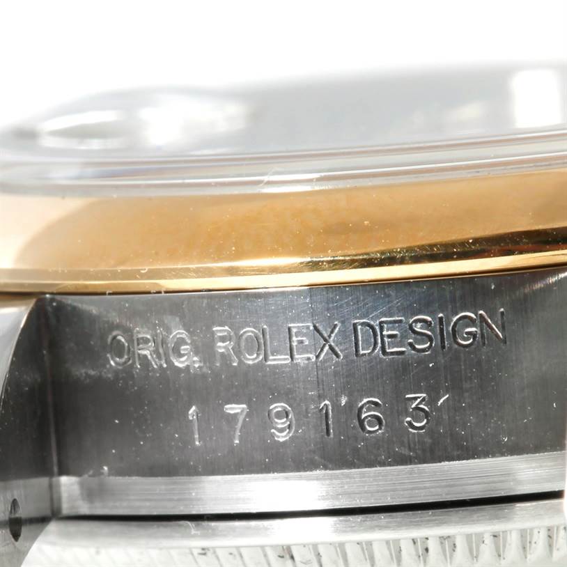 The image shows a close-up of the case side for a Rolex Datejust 179163 Women's Steel and Gold (two tone) Silver Dial 179163 Women's Steel and Gold (two tone) Silver Dial model with engraving and part of the bezel visible.