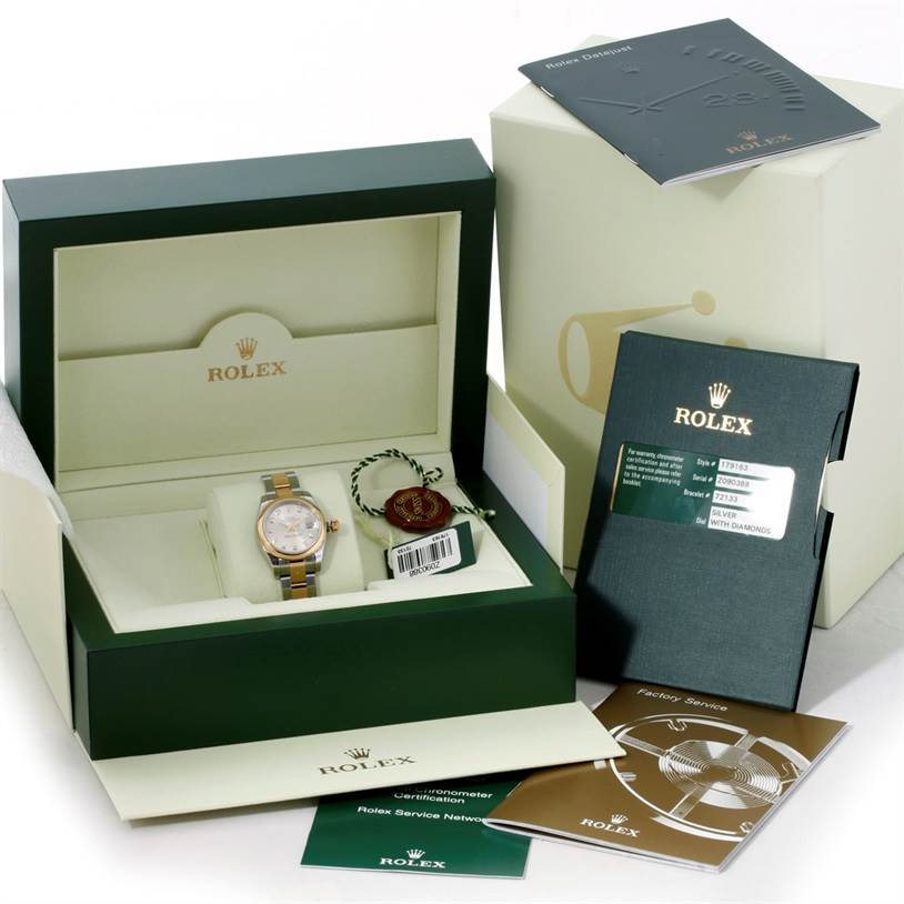 The image shows a Rolex Datejust 179163 Women's Steel and Gold (two tone) Silver Dial 179163 Women's Steel and Gold (two tone) Silver Dial watch in its box with accompanying booklets and tags placed around the box.