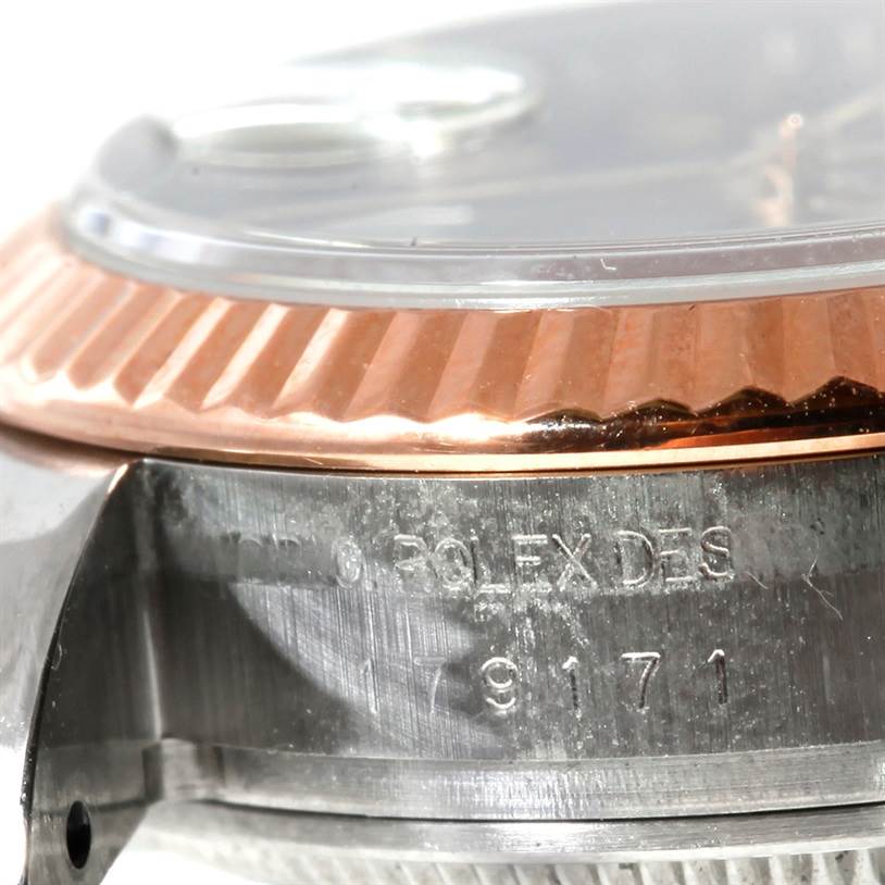 The image shows a close-up of the side of a Rolex Datejust 179171 Women's Steel and Gold (two tone) Grey Dial 179171 Women's Steel and Gold (two tone) Grey Dial watch, featuring the bezel and part of the case with inscriptions.