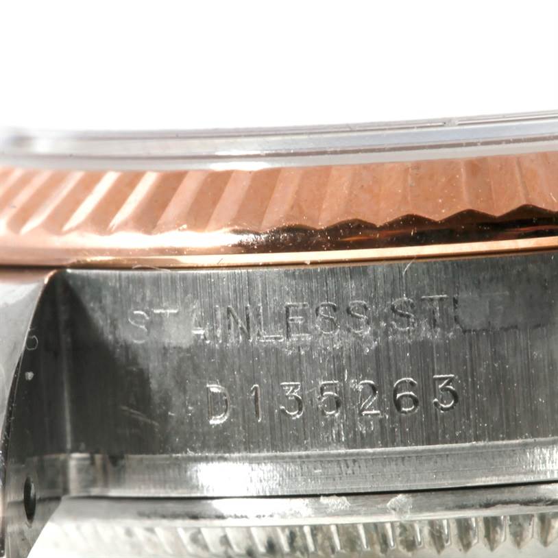 This close-up photo of a Rolex Datejust 179171 Women's Steel and Gold (two tone) Grey Dial 179171 Women's Steel and Gold (two tone) Grey Dial watch showcases its stainless steel case and fluted bezel, highlighting the serial number.