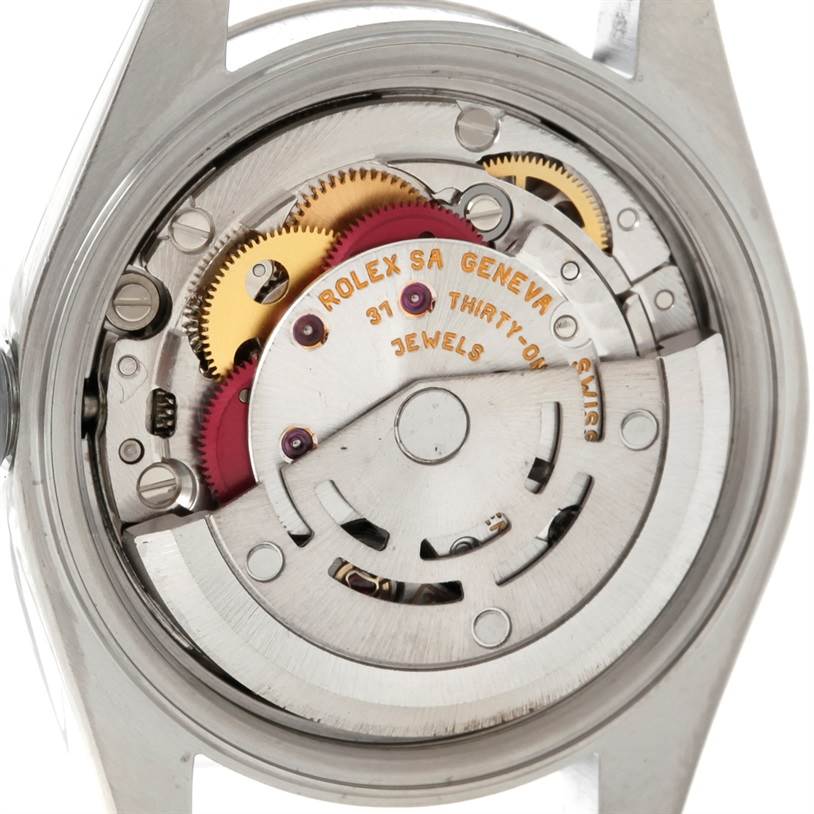 This image shows a close-up of the internal mechanism of a Rolex Datejust 79174 Women's Stainless Steel Silver Dial 79174 Women's Stainless Steel Silver Dial watch, focusing on the gears and movements.