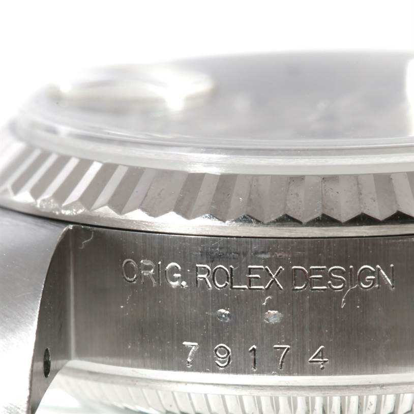 The image shows a close-up of the side case, bezel, and part of the crystal of a Rolex Datejust 79174 Women's Stainless Steel Silver Dial 79174 Women's Stainless Steel Silver Dial watch, with the model number visible.