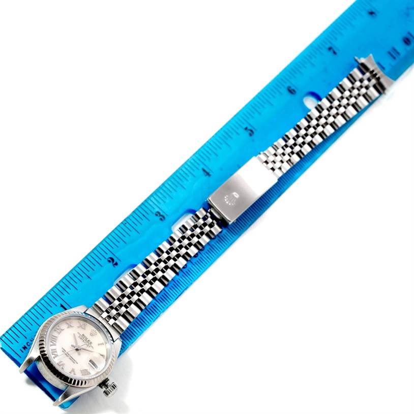 The image shows a horizontal view of a Rolex Datejust 79174 Women's Stainless Steel Mother of Pearl Dial 79174 Women's Stainless Steel Mother of Pearl Dial watch, focusing on the face and band, positioned alongside a blue ruler.