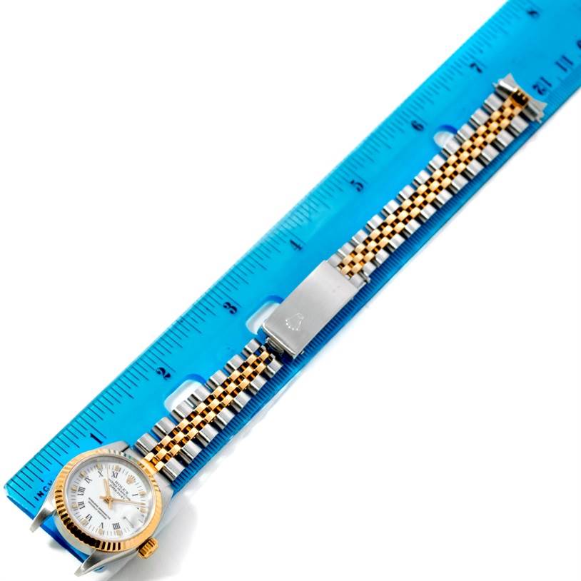 The Rolex Datejust 69173 Women
s Stainless Steel White Dial 69173 Women
s Stainless Steel White Dial watch is placed flat on a blue ruler, showing the entire watch including the dial, bezel, and bracelet.