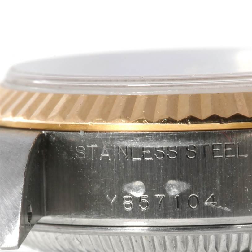This close-up of the Rolex Datejust 79173 Women's Stainless Steel Silver Dial 79173 Women's Stainless Steel Silver Dial watch shows the stainless steel casing and part of the fluted bezel.