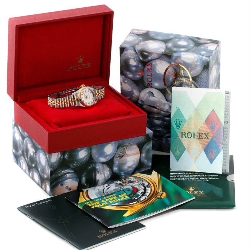 The Rolex Datejust 79173 Women's Stainless Steel Silver Dial 79173 Women's Stainless Steel Silver Dial watch is shown from the front in its open case, surrounded by boxes and booklets.