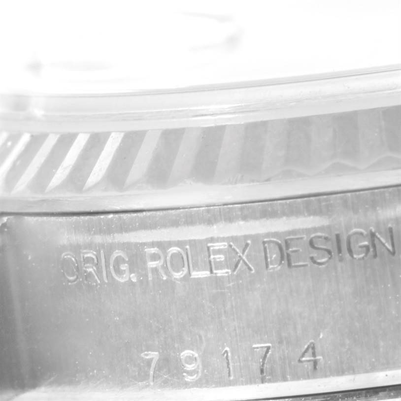 This is a close-up angle showing the engraved caseback of a Rolex Datejust 79174 Women
s Stainless Steel White Dial 79174 Women
s Stainless Steel White Dial watch, emphasizing the "ORIG. ROLEX DESIGN" inscription.