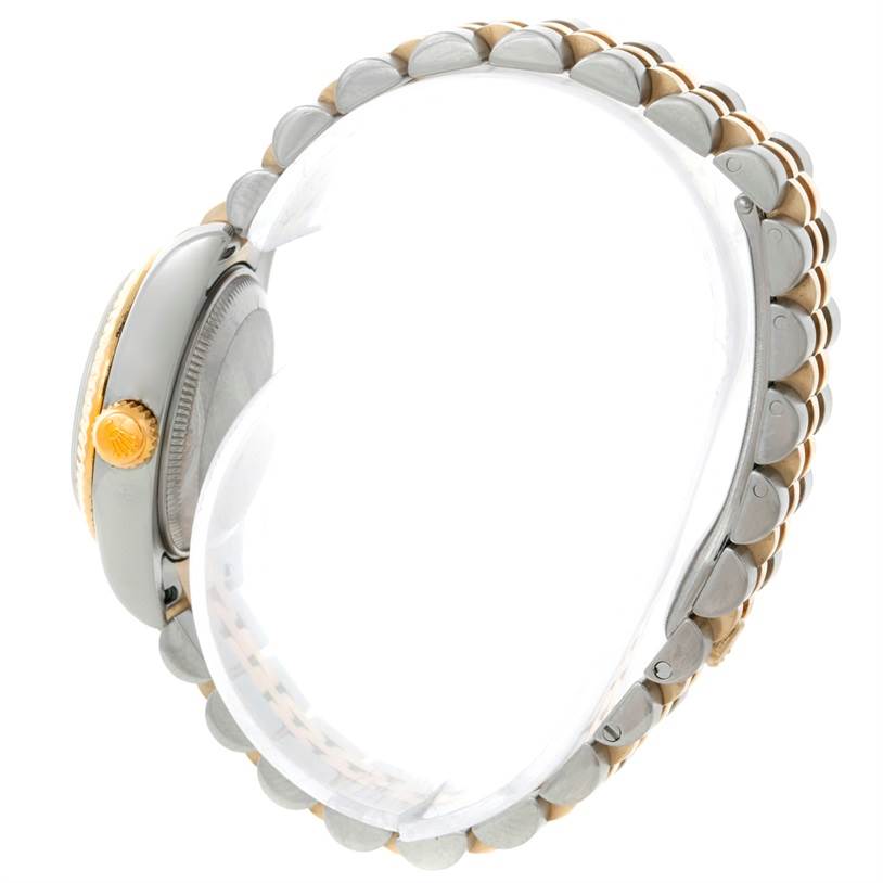 This side view of a Rolex Datejust 179173 Women's Steel and Gold (two tone) Champagne Dial 179173 Women's Steel and Gold (two tone) Champagne Dial watch showcases the crown, case, and bracelet.