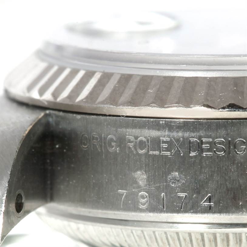 This image shows a close-up angle of the casing, serial number, and bezel of the Rolex Datejust 79174 Women's Stainless Steel Blue Dial 79174 Women's Stainless Steel Blue Dial watch model.