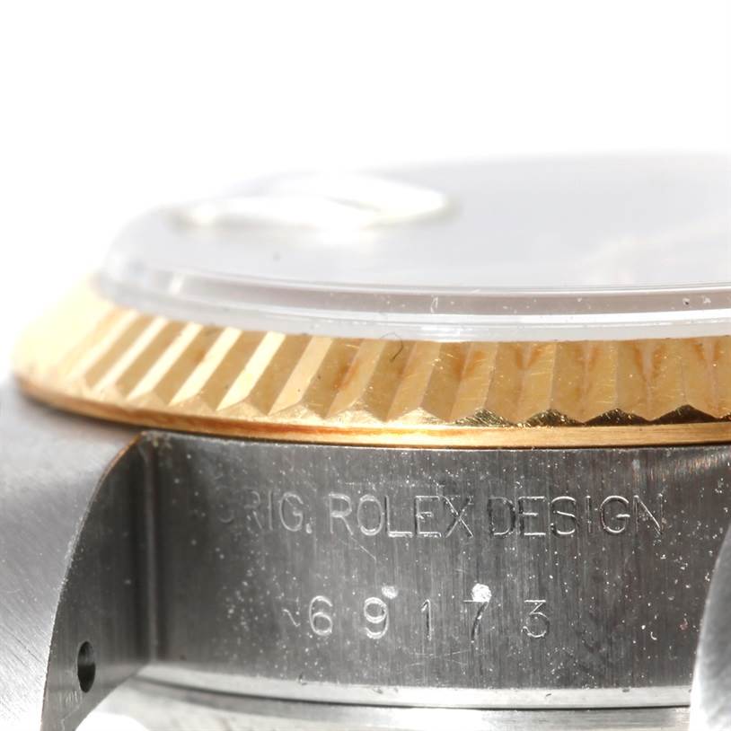 This image shows a close-up side view of the bezel and case of a Rolex Datejust 69173 Women's Stainless Steel Champagne Dial 69173 Women's Stainless Steel Champagne Dial watch, revealing the Rolex engraving.