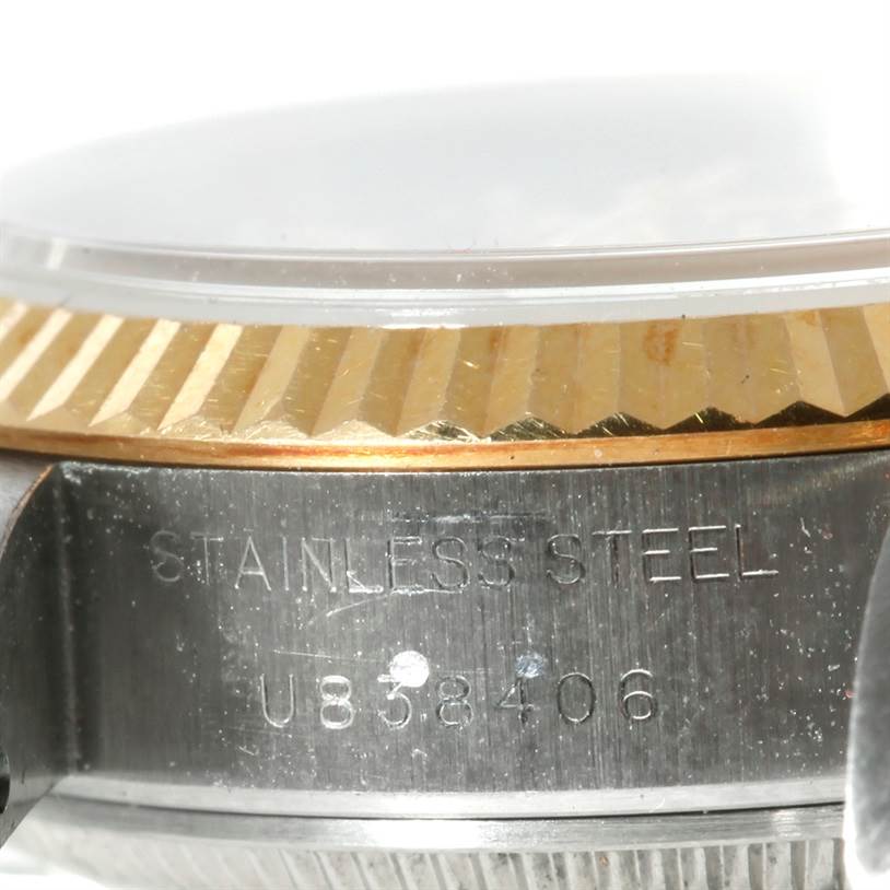 The image shows a close-up of the side of a Rolex Datejust 69173 Women's Stainless Steel Champagne Dial 69173 Women's Stainless Steel Champagne Dial, highlighting the stainless steel case and the fluted bezel.