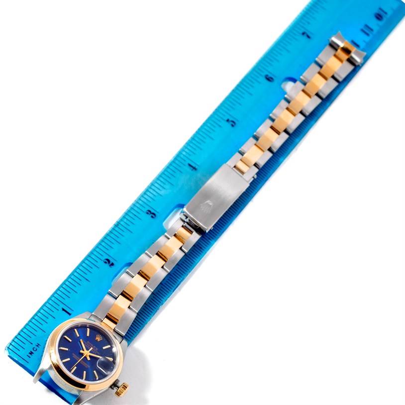The image shows a Rolex Datejust 69163 Women's Stainless Steel Blue Dial 69163 Women's Stainless Steel Blue Dial watch laid flat next to a ruler, featuring its face, bezel, and bracelet with the clasp visible.