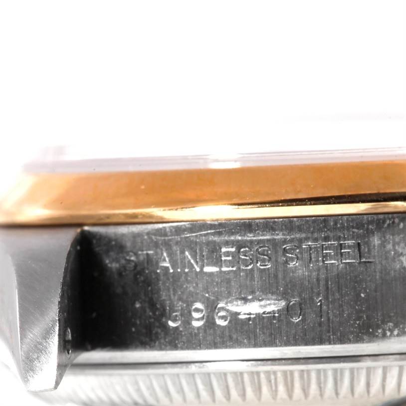 This close-up image of a Rolex Datejust 69163 Women's Stainless Steel Blue Dial 69163 Women's Stainless Steel Blue Dial watch shows the side view of the case with "STAINLESS STEEL" and serial number.