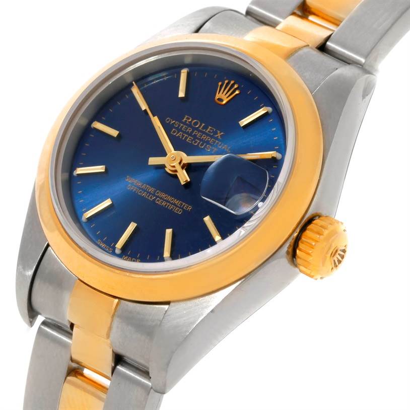 The image shows a close-up view of a Rolex Datejust 69163 Women's Stainless Steel Blue Dial 69163 Women's Stainless Steel Blue Dial watch, highlighting its blue dial, gold bezel, crown, and part of the bracelet.