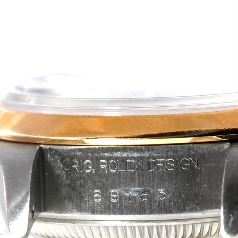 The image shows a close-up side view of the case of a Rolex Datejust 69163 Women's Stainless Steel Blue Dial 69163 Women's Stainless Steel Blue Dial, featuring the bezel and part of the case with engravings.