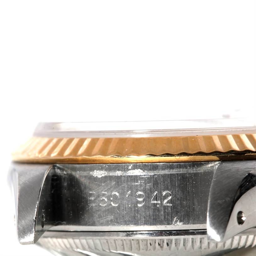 This image shows the side view of a Rolex Datejust 69173 Women's Stainless Steel Pink Dial 69173 Women's Stainless Steel Pink Dial watch, focusing on the case, bezel, and serial number.