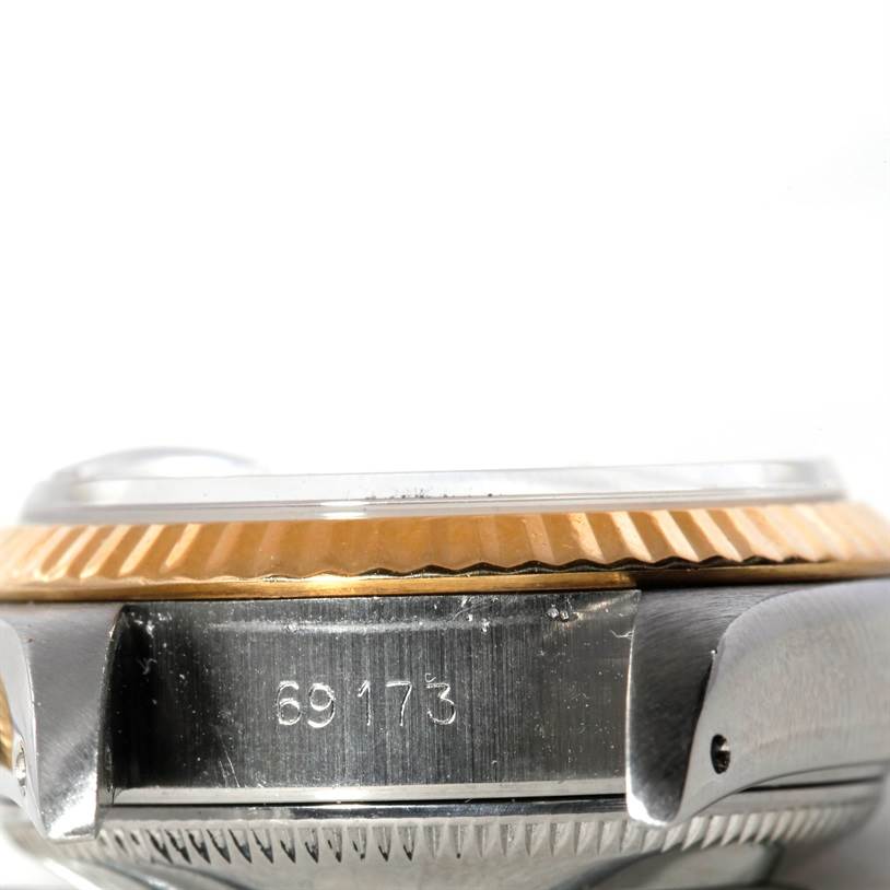 This image shows a close-up side view of a Rolex Datejust 69173 Women's Stainless Steel Pink Dial 69173 Women's Stainless Steel Pink Dial watch case, focusing on its fluted bezel and reference number.