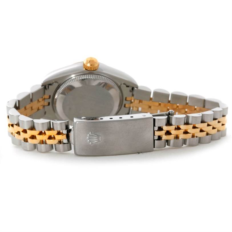 This image shows the back case and clasp of a Rolex Datejust 79173 Women's Stainless Steel Champagne Dial 79173 Women's Stainless Steel Champagne Dial watch, with a two-tone metal bracelet.