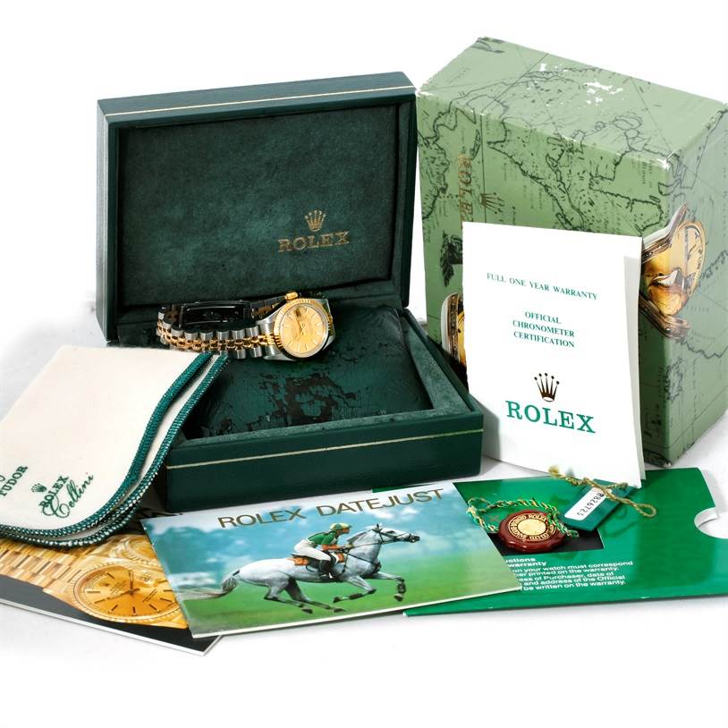 The image shows a Rolex Datejust 69173 Women's Stainless Steel Champagne Dial 69173 Women's Stainless Steel Champagne Dial watch with its box, warranty card, booklet, tags, and a cleaning cloth.