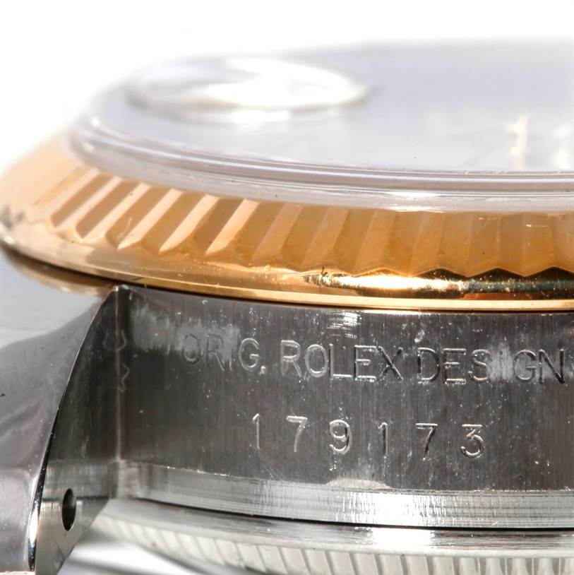 This close-up shows the side of a Rolex Datejust 179173 Women's Steel and Gold (two tone) Mother of Pearl Dial 179173 Women's Steel and Gold (two tone) Mother of Pearl Dial watch, focusing on the case and the fluted bezel.