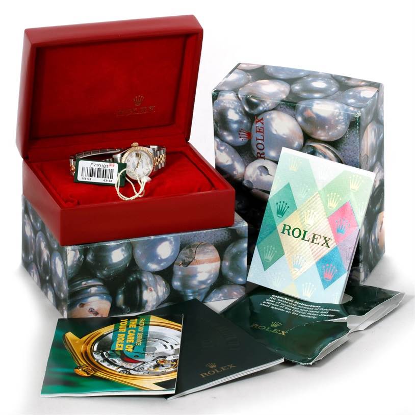 The image shows a Rolex Datejust 179173 Women's Steel and Gold (two tone) Mother of Pearl Dial 179173 Women's Steel and Gold (two tone) Mother of Pearl Dial watch inside its open red box, alongside manuals and outer packaging.