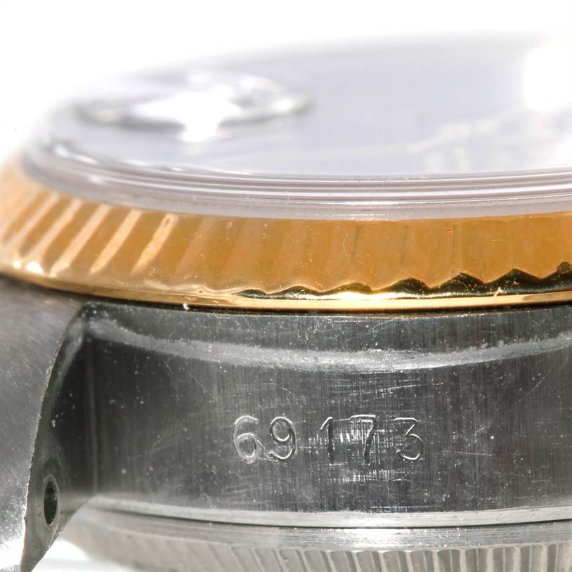 This image shows a close-up of the side of a Rolex Datejust 69173 Women
s Stainless Steel Black Dial 69173 Women
s Stainless Steel Black Dial watch, featuring the model number 69173 and part of the bezel and case.