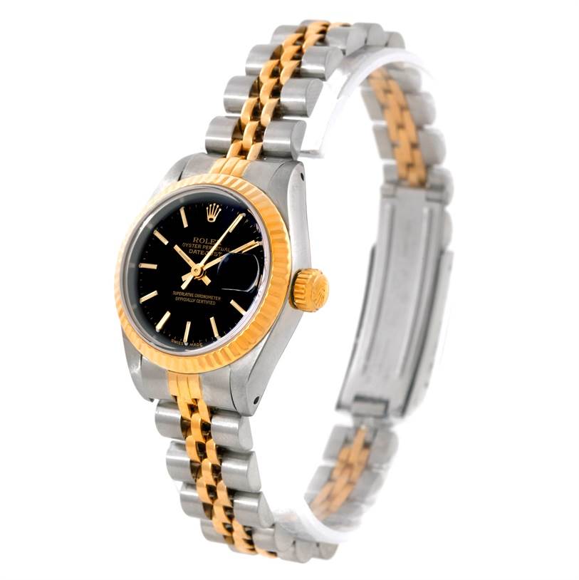 The Rolex Datejust 69173 Women
s Stainless Steel Black Dial 69173 Women
s Stainless Steel Black Dial watch is shown at a slight angle, displaying its black dial, gold fluted bezel, and two-tone metal bracelet.