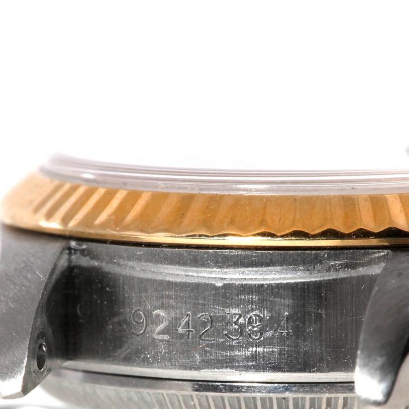 This image shows a close-up of the serial number area and fluted bezel of a Rolex Datejust 69173 Women
s Stainless Steel Black Dial 69173 Women
s Stainless Steel Black Dial watch.