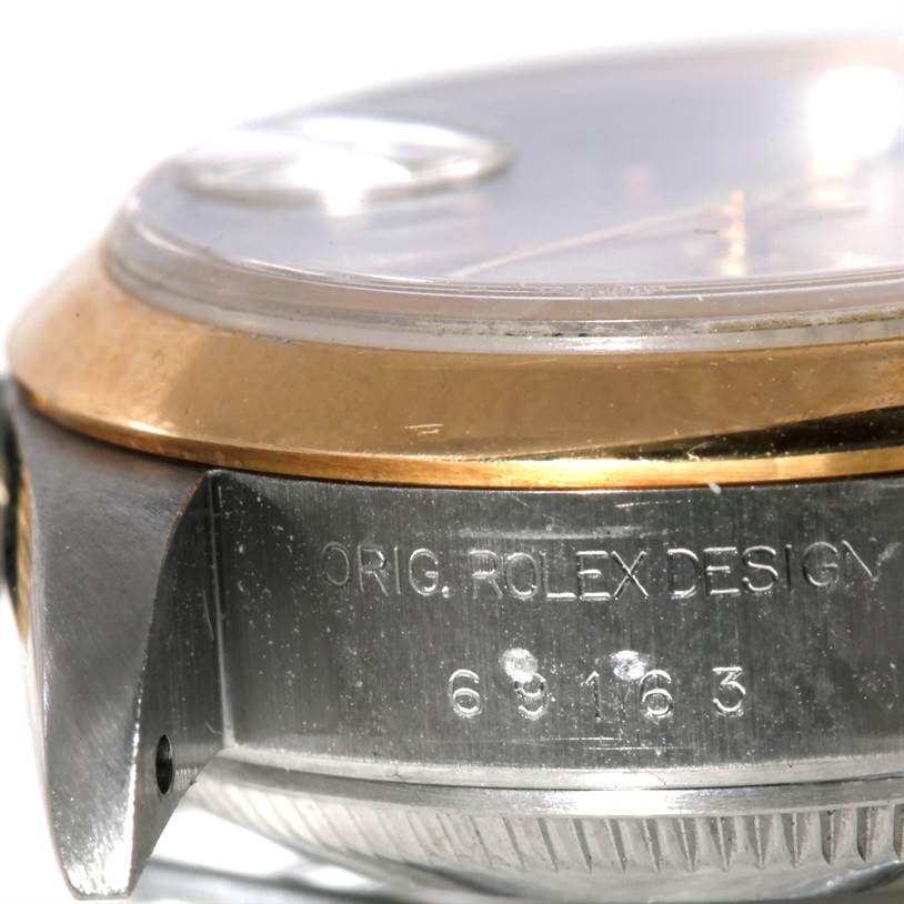 The image shows a close-up side angle of the Rolex Datejust 69173 Women's Stainless Steel Silver Dial 69173 Women's Stainless Steel Silver Dial watch, focusing on the bezel, case, and engraved model number.