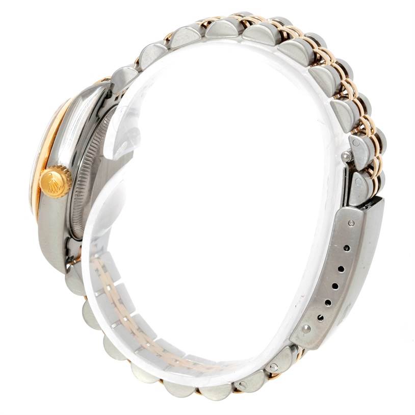 The image shows a side view of a Rolex Datejust 69173 Women's Stainless Steel Silver Dial 69173 Women's Stainless Steel Silver Dial watch featuring its crown, case, and bracelet.